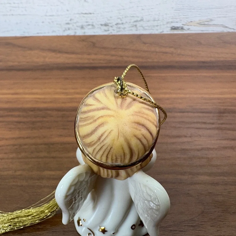 Lenox May birthstone Porcelain Angel Ornament features a hand-painted gold halo